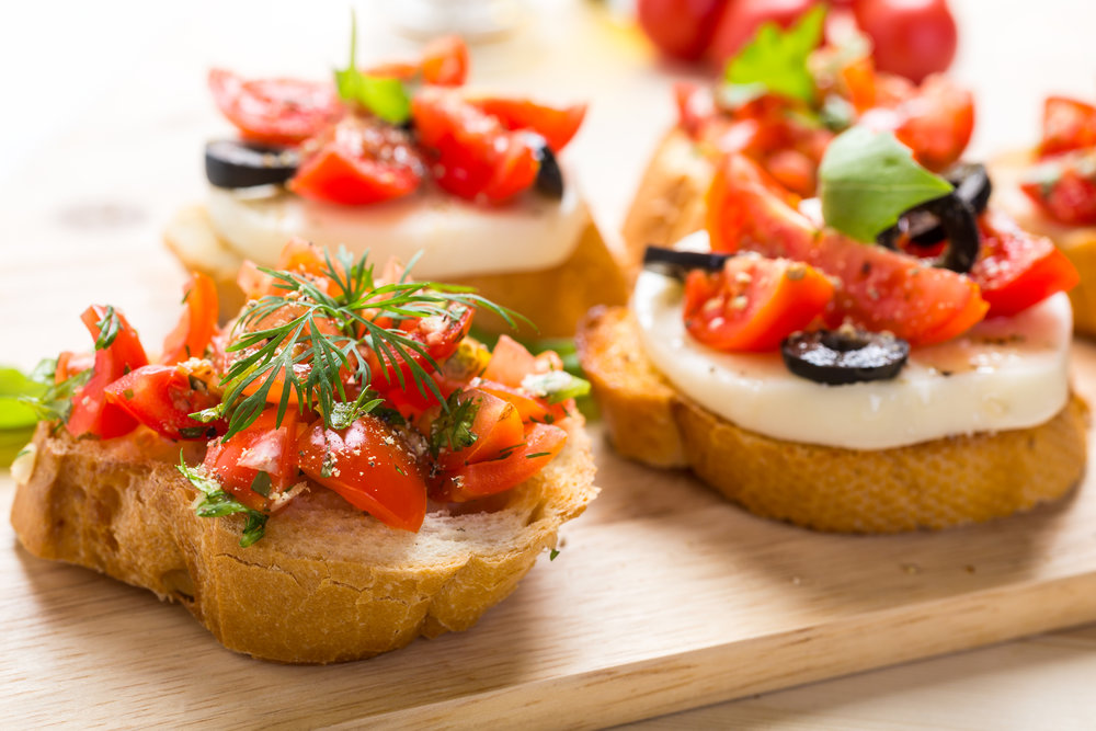 Italian Appetizer Bruschetta with roasted tomatoes, mozzarella cheese, garlic and herbs